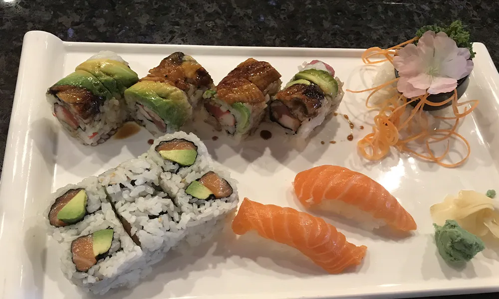 Mixed sushi plate with unagi avocado rolls, salmon maki and fresh salmon nigiri with ginger and wasabi garnish at Sakura Japanese Restaurant, a Japanese restaurant in Wilmington
